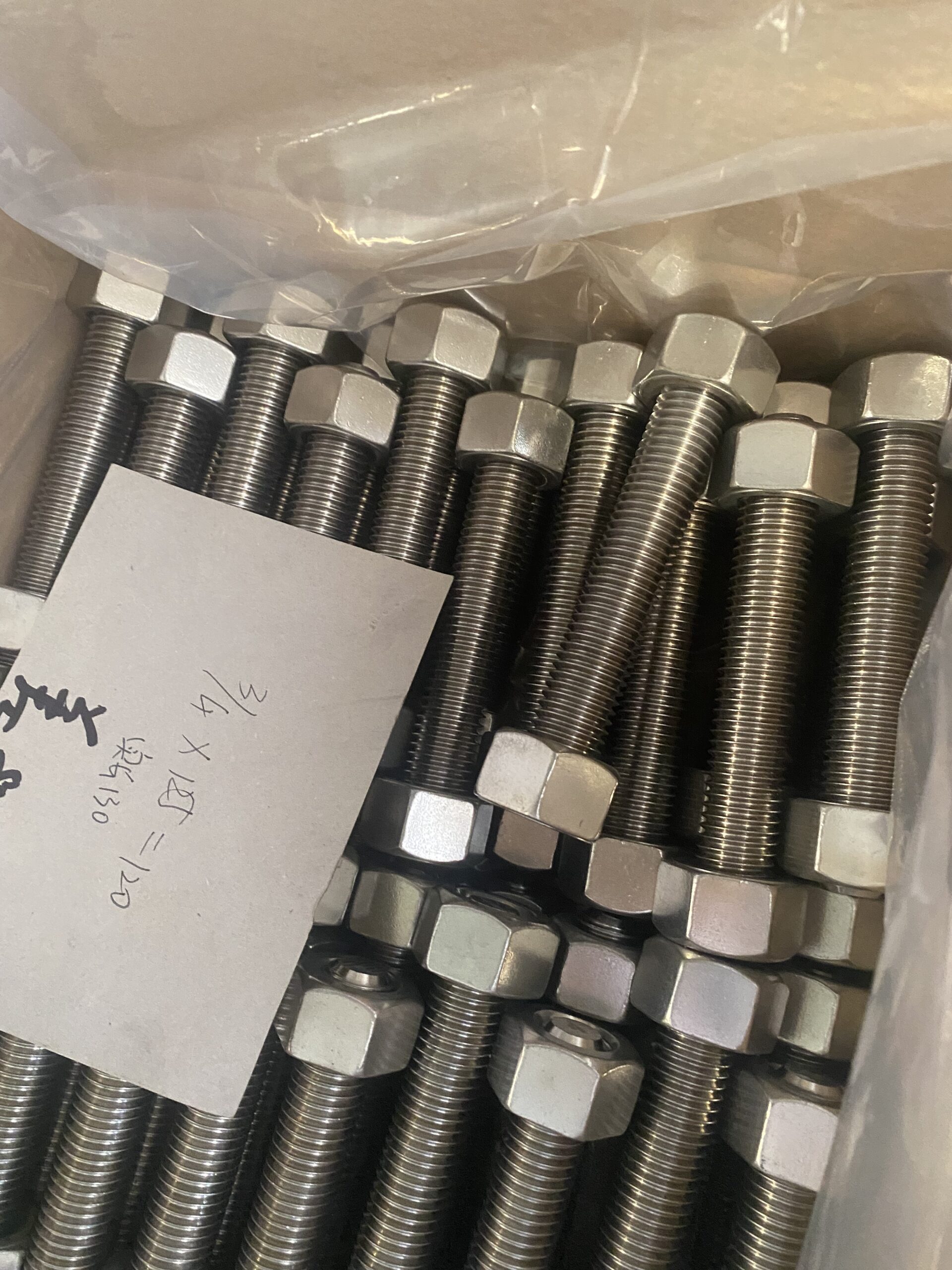 A heavy-duty Monel 400 hex bolt featuring a slightly yellowish, metallic luster and clean threading