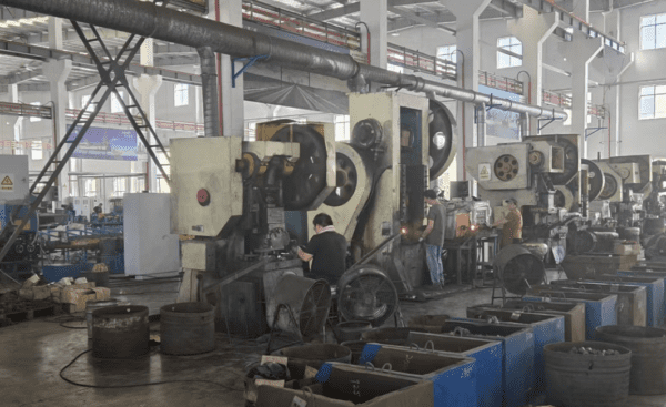Industrial CNC machining center manufacturing high-precision Inconel and titanium fasteners in a professional factory setting